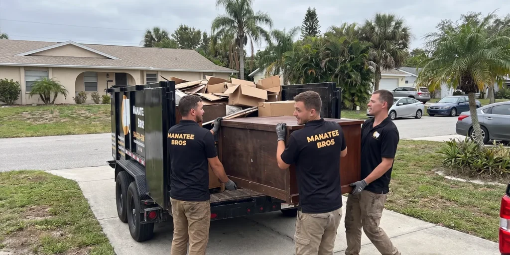 Manatee Junk Bros crew loading a trailer during a junk removal job in Sarasota, FL